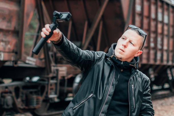 Handsome Guy Making Selfie Using Action Camera at Railway - Fotografie, Obrázek