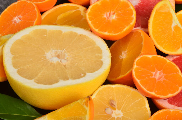 Close-up of sliced citrus fruits, Various citrus fruits, Citrus background - Foto, Bild