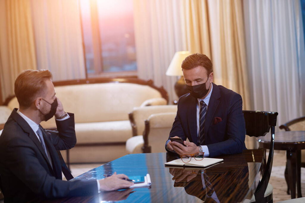 business people wearing crona virus protection face mask on meeting - 写真・画像