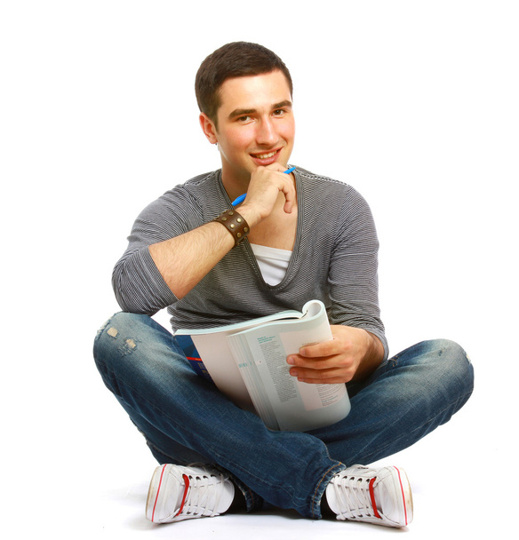 College guy sitting on the floor and studying - Photo, image