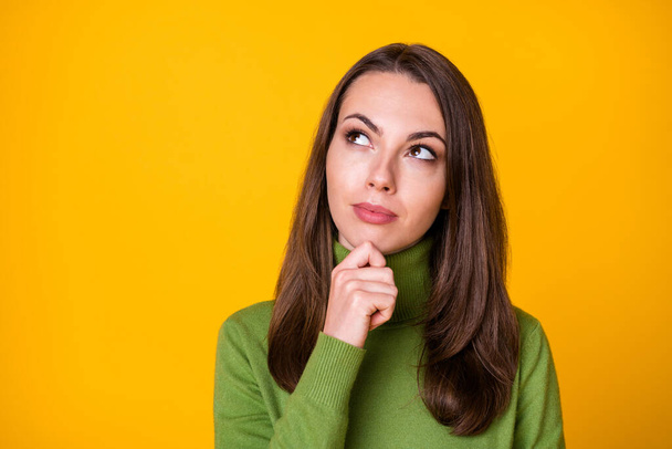 Close-up portrait of pretty smart bewildered girl making decision copy space isolated over shine yellow color background - Фото, изображение