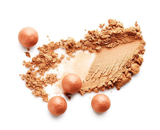 Face powder stroke and bronzing pearls isolated on white background - 写真・画像