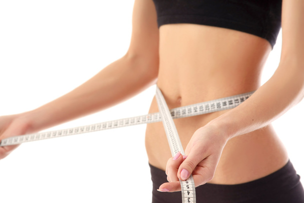 Woman measure her waist belly by metre-stick - Φωτογραφία, εικόνα