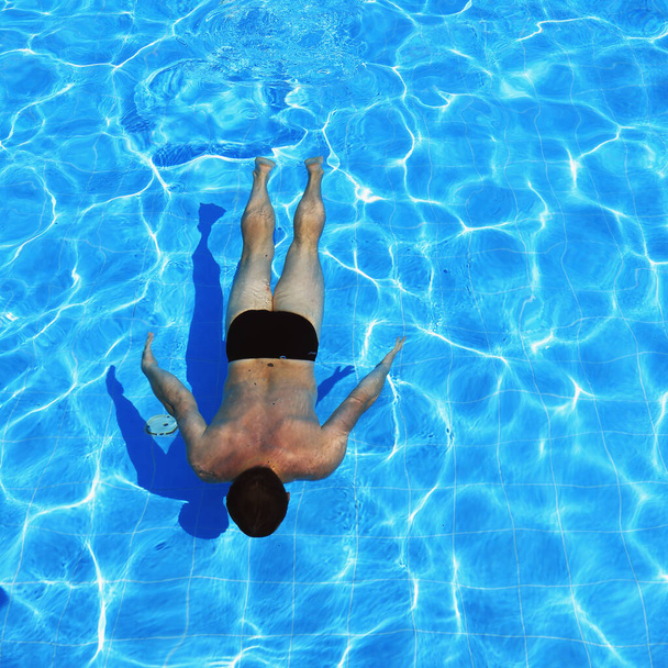 isolated azure water pool and swimmer in the water  - Photo, image