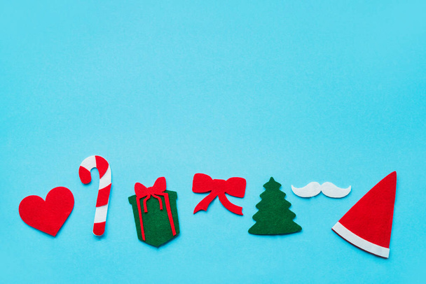 Christmas stick costume props on bright blue background. Top view, copy space for text - 写真・画像
