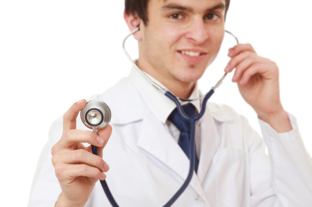 Young male doctor listening - Foto, afbeelding