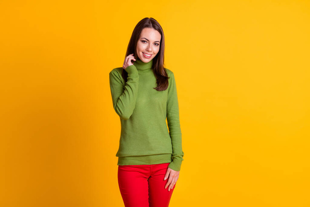 Portrait of attractive slender cheerful shy girl wearing casual clothing isolated over bright yellow color background - Fotografie, Obrázek