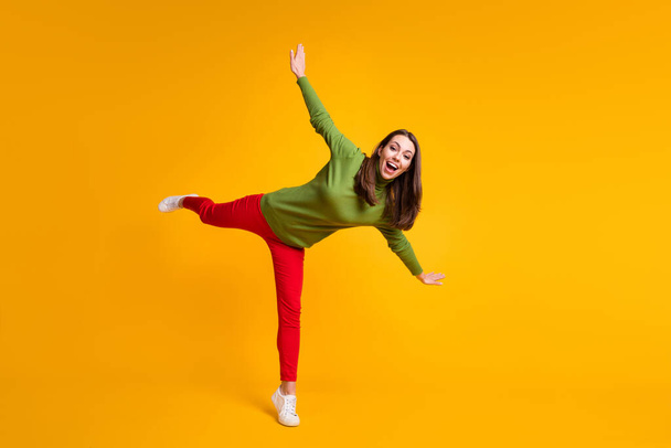 Full length body size view of nice overjoyed cheerful girl jumping having fun isolated on bright yellow color background - Foto, Imagem