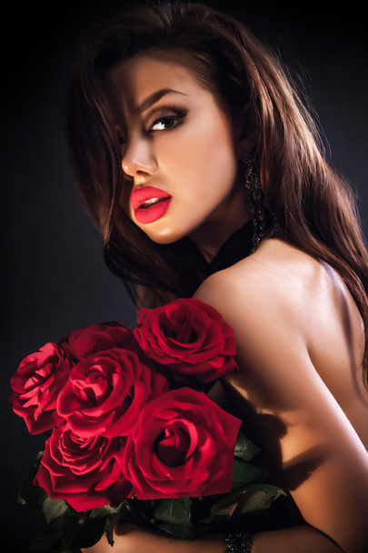 Beautiful female holding red roses bouquet, valentines day. - Valokuva, kuva
