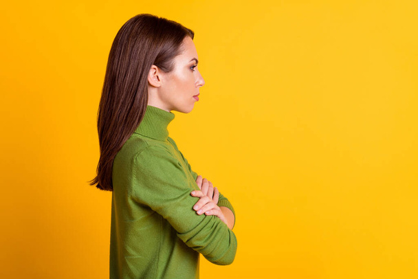 Profile photo of bossy lady hold arms crossed look side empty space wear casual sweater isolated yellow color background - Fotografie, Obrázek