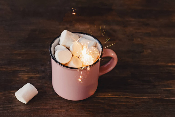 Mug of hot chocolate or cacao with marshmallows with sparkler. - Foto, Imagem
