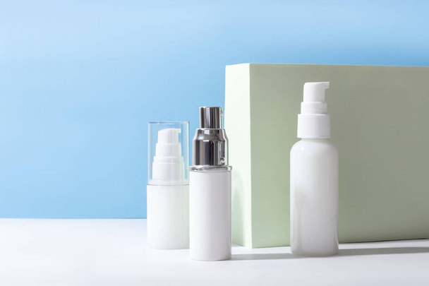 Set of white cosmetic bottles and jars with hard shadows. Beauty salon concept. - Photo, Image
