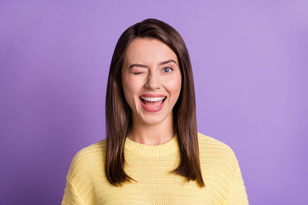 Photo portrait of winking young girl with closed eye smiling isolated on bright color purple background - Fotografie, Obrázek