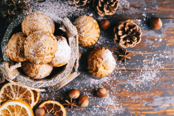 Sweet dessert profiteroles. Christmas composition. Christmas or New Year background. - Fotografie, Obrázek