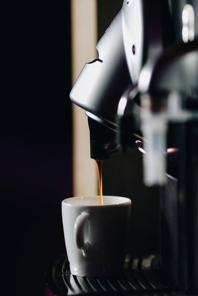 Preparing a cup of espresso coffee using a coffee machine. - Valokuva, kuva