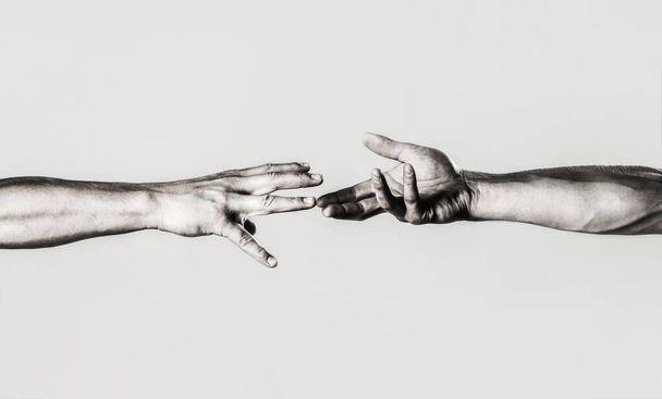 Two hands, helping arm of a friend, teamwork. Rescue, helping gesture or hands. Close up help hand. Helping hand concept, support. Helping hand outstretched, isolated arm, salvation. Black and white - Photo, Image