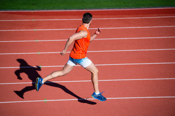 sportsman guy in sportswear run fast sprinting on running track, stamina - Foto, immagini