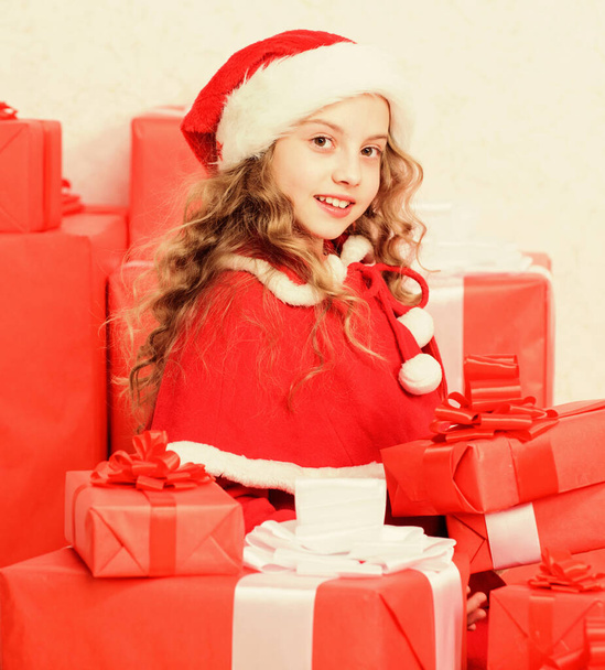 Little santas helper concept. Explore christmas gifts. Unpacking christmas gift. Kid excited about opening christmas present. Girl celebrate christmas. Kid helping santa. New year holiday tradition - Foto, Imagen