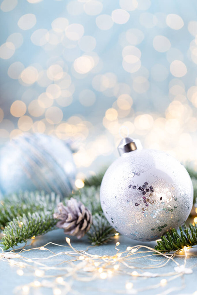 Christmas spruce with ball and blurred shiny lights. - Fotó, kép