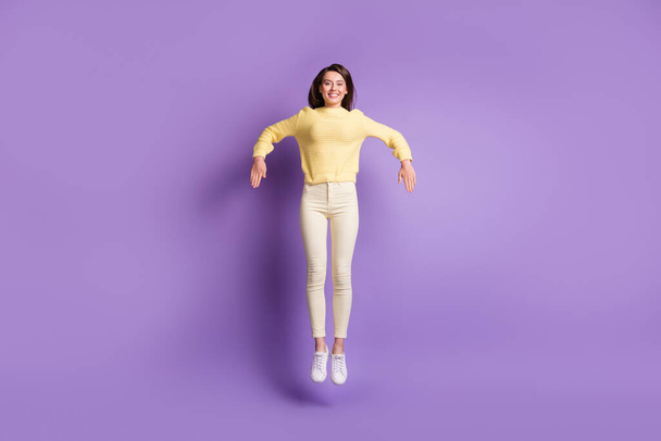 Photo portrait full body view of girl jumping up making robot moves dancing isolated on bright purple colored background - Foto, afbeelding