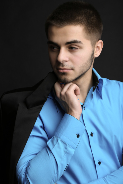 Handsome young man in suit on dark background - Foto, Imagem