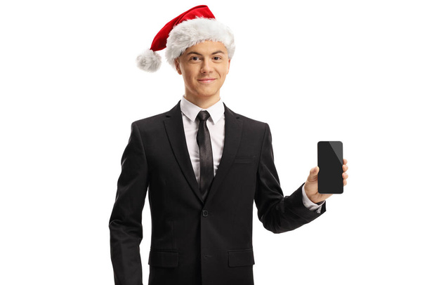 Portrait of a young man with a santa hat showing a smartphone isolated on white background - Valokuva, kuva