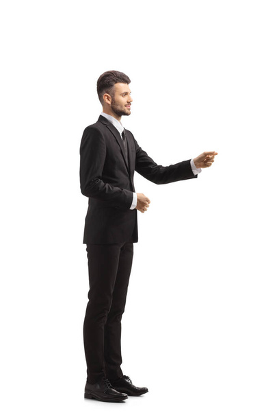 Full length profile shot of a businessman gesturing with hand isolated on white background - Valokuva, kuva