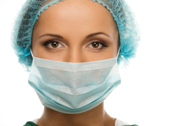 Молода жінка-лікар у кепці та масці для обличчя
 - Фото, зображення