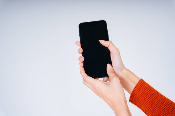 Hand of woman holding smartphone for mock up and copy space at the screen isolate on white background. - Φωτογραφία, εικόνα
