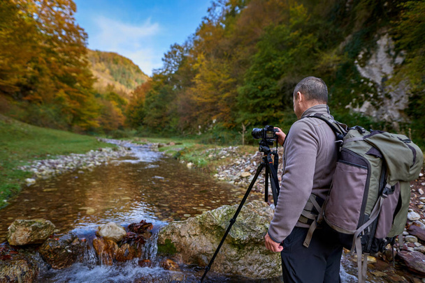 Professional nature photographe with large backpack, camera and tripod - Φωτογραφία, εικόνα