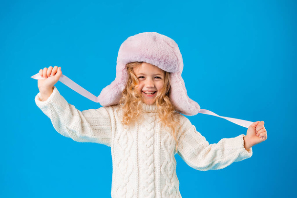 portrait of laughing little girl in winter hat and knitted sweater - Fotoğraf, Görsel