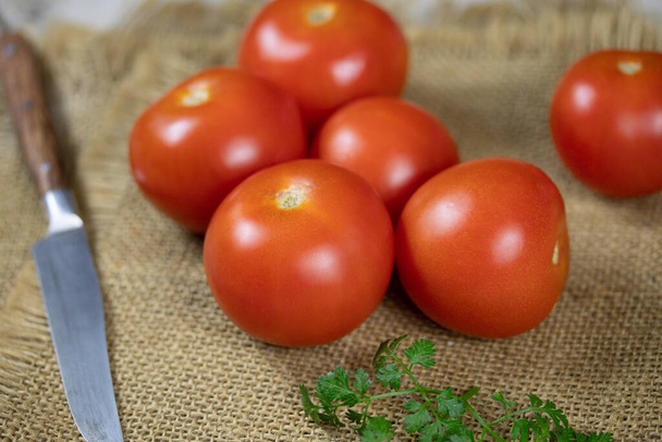Several cherry tomatoes on a cloth napkin. - Фото, зображення