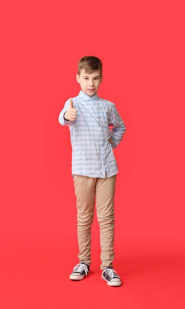 Cute boy showing thumb-up on color background - Photo, Image