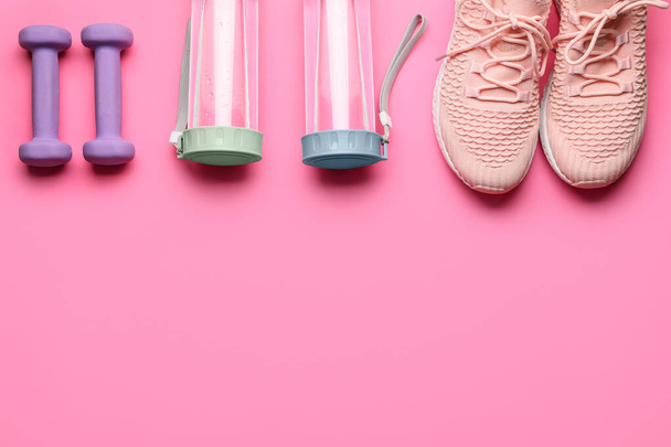 Bottles, sports shoes and dumbbells on color background - Photo, Image
