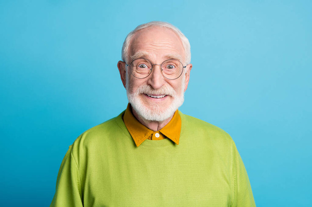 Photo of pensioner grandpa beaming smile look camera wear glasses green pullover isolated blue color background - Фото, изображение