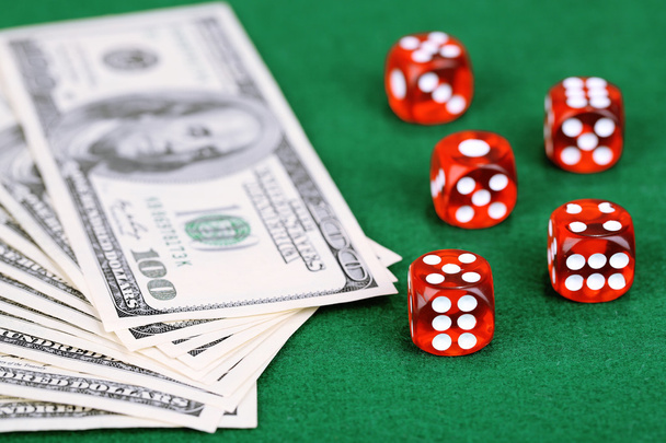Red dices and dollars on green background - 写真・画像