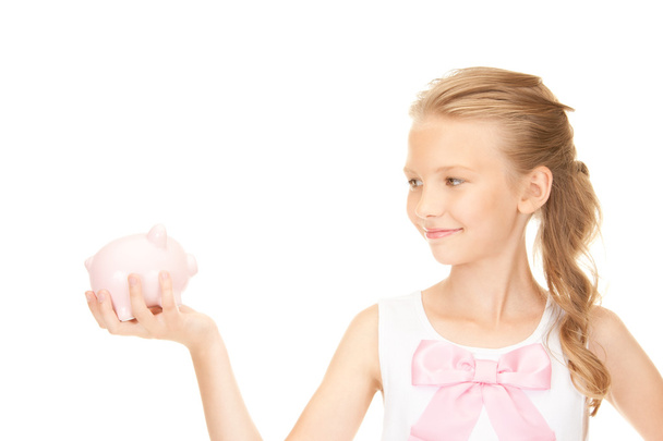 Lovely teenage girl with piggy bank - Foto, afbeelding
