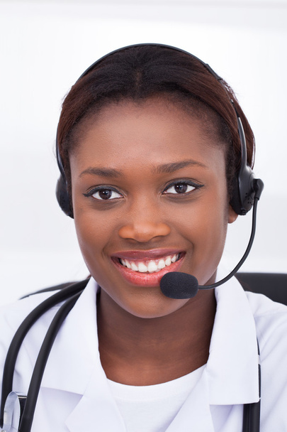 Confident Receptionist Using Headset In Hospital - Foto, Imagem
