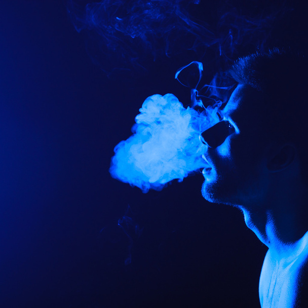 Close up portrait of young man smoking cigarette - Foto, immagini