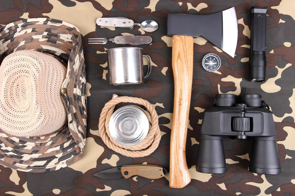 Equipment for trekking on camouflage background - Photo, Image