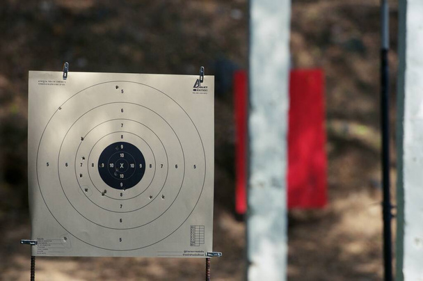 Target practice at outdoor shooting range. paper target and steel plate target - Фото, изображение