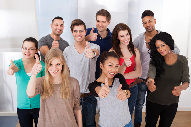 Confident University Students Gesturing Thumbs Up - Zdjęcie, obraz