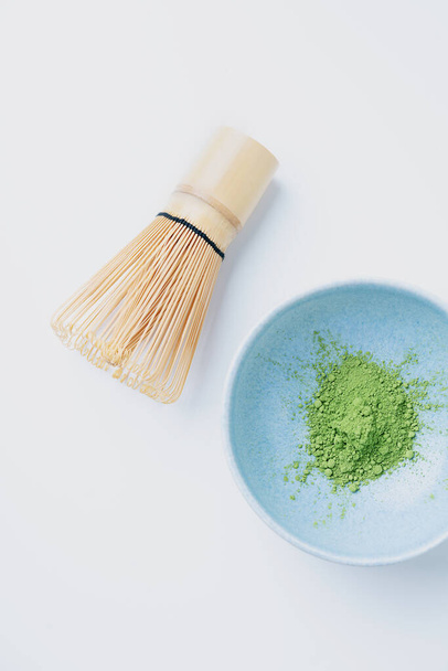 Traditional Japanese matcha tea  powder with bamboo whisk chasen in ceramic bowl Isolated. Flat Lay. Top View - Photo, Image