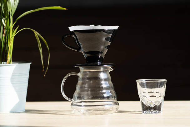 brewing coffee in a funnel. the Hario v-60 coffee funnel is on the server. beautiful table with dark background. the process of brewing the coffee specialty. Pour Over In Funnel. Alternative Method - Fotografie, Obrázek