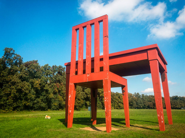 Lo scrittore (the writer) of Giancarlo Neri in the Monza Park. 10-17-2020. Chair and desk, art installation surrounded by the greenery of the park where it fits harmoniously, creating a link with the surrounding nature - Photo, image