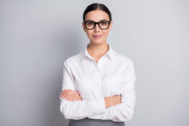 Photo of self-assured business lady crossed hands look camera wear glasses white shirt isolated grey color background - Fotografie, Obrázek