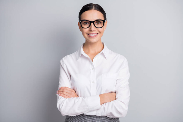 Photo of confident chief lady folded hands toothy smile wear specs white shirt isolated grey color background - Foto, immagini