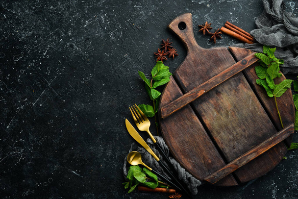 Culinary black background with utensils and spices. Top view. Rustic style. - Foto, imagen