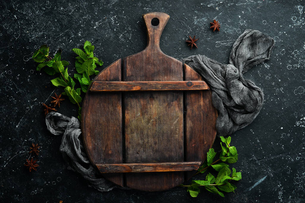 Culinary black background with utensils and spices. Top view. Rustic style. - 写真・画像