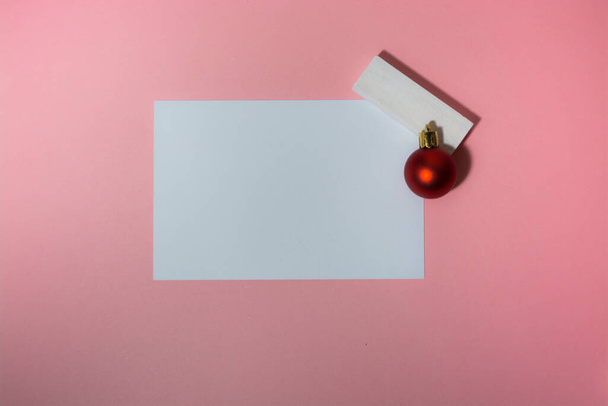 Christmas greeting card over pink background with Christmas tree balls  - Φωτογραφία, εικόνα
